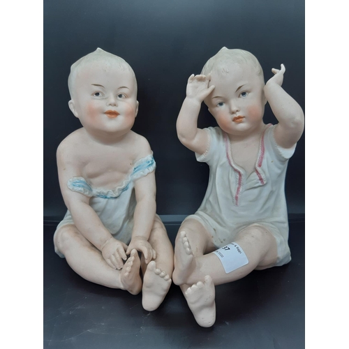 37 - A pair of Gebrüder Heubach of Licht and Sonneberg, Germany, Piano Baby figurines - Measuring approx.... 