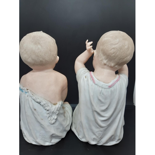 37 - A pair of Gebrüder Heubach of Licht and Sonneberg, Germany, Piano Baby figurines - Measuring approx.... 