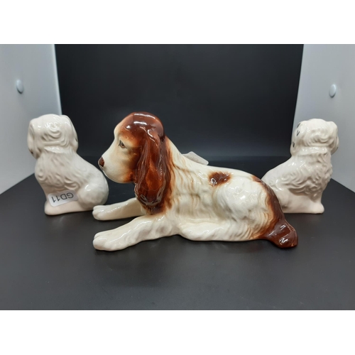 38 - Three figurines to include a Sylvac Show Cocker Spaniel and a pair of Royal Doulton miniature Spanie... 