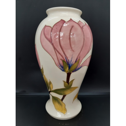 5 - A Moorcroft pottery vase in the pink magnolia pattern on cream ground - measuring approx. 26cm tall