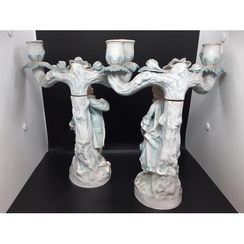 50 - A pair of 19th century German Ernst Boone & Sohne porcelain figural two branch candelabras - model n... 