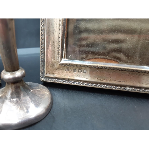 64 - Three hallmarked silver items to include a Sheffield silver bud vase dated 1906 and a pair of Birmin... 