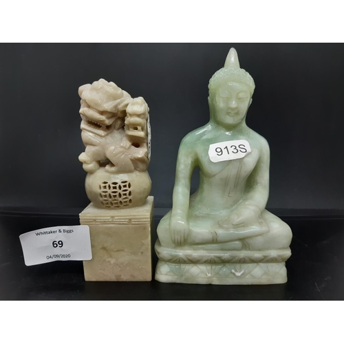 69 - Two oriental ornaments to include a carved jade effect Thai Buddha together with a carved soap stone... 