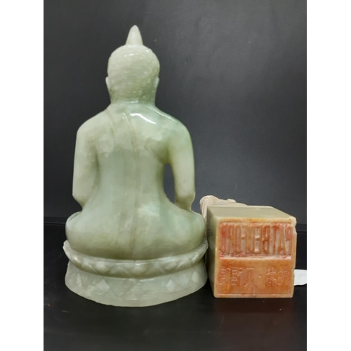 69 - Two oriental ornaments to include a carved jade effect Thai Buddha together with a carved soap stone... 