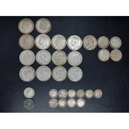 74 - A collection of various mid 20th century .500 grade silver coins to include a 1930 Florin, 1933 shil... 