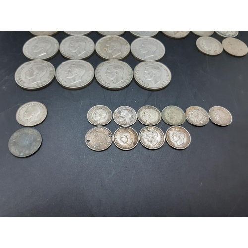 74 - A collection of various mid 20th century .500 grade silver coins to include a 1930 Florin, 1933 shil... 