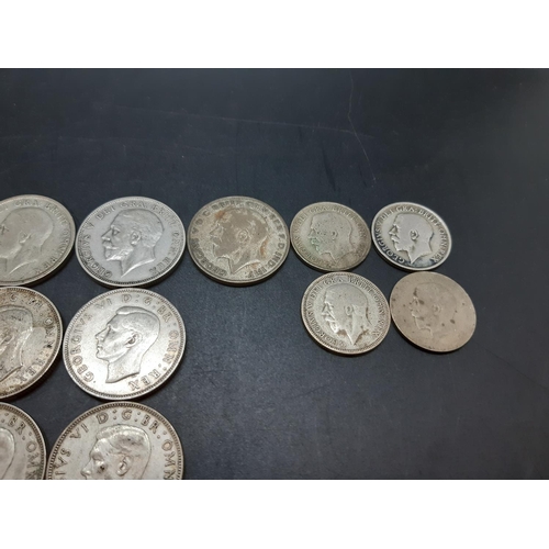 74 - A collection of various mid 20th century .500 grade silver coins to include a 1930 Florin, 1933 shil... 