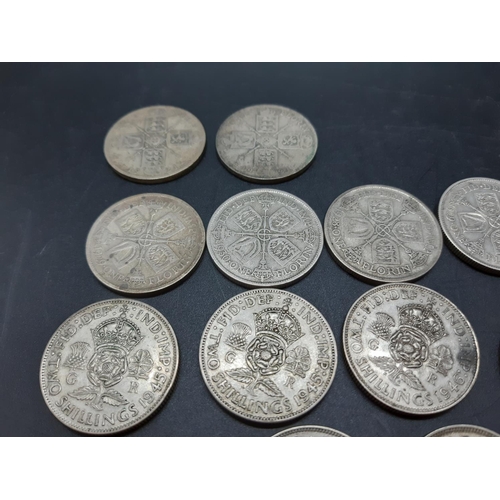 74 - A collection of various mid 20th century .500 grade silver coins to include a 1930 Florin, 1933 shil... 