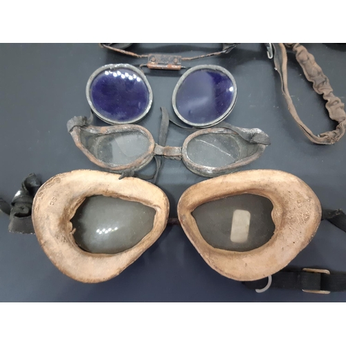 78 - A collection of four early automobile driving goggles together with a pair of antique welding goggle... 