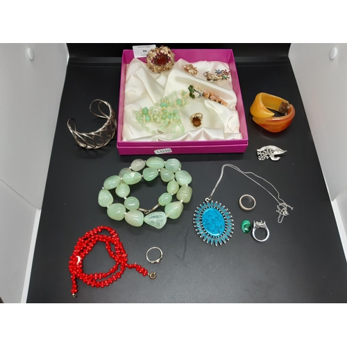 94 - A box containing a collection of various costume jewellery to include a hallmarked silver ladies ban... 