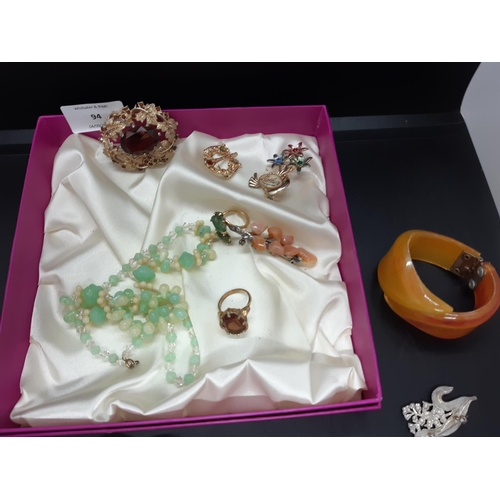 94 - A box containing a collection of various costume jewellery to include a hallmarked silver ladies ban... 