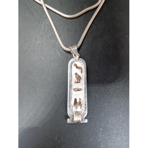 99 - A hallmarked silver ingot with gold coloured Egyptian hieroglyphics and hallmarked 925 silver chain