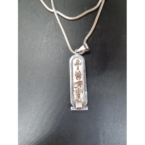 99 - A hallmarked silver ingot with gold coloured Egyptian hieroglyphics and hallmarked 925 silver chain