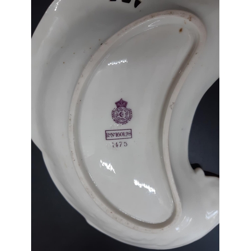 1 - A Royal Worcester blush ivory kidney shaped trinket dish with gold tubelined leaf design and acanthu... 