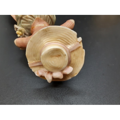 10 - A pair of early/mid 20th century Royal Dux figurines of young boy and girl flower sellers with trian... 