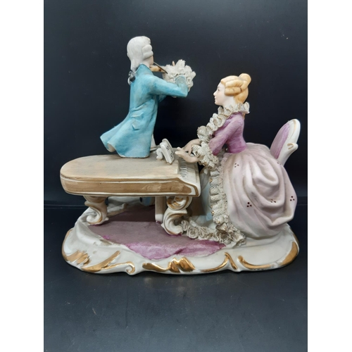 14 - A late 19th/early 20th century Sitzendorf style porcelain figurine of two musicians, a lady playing ... 