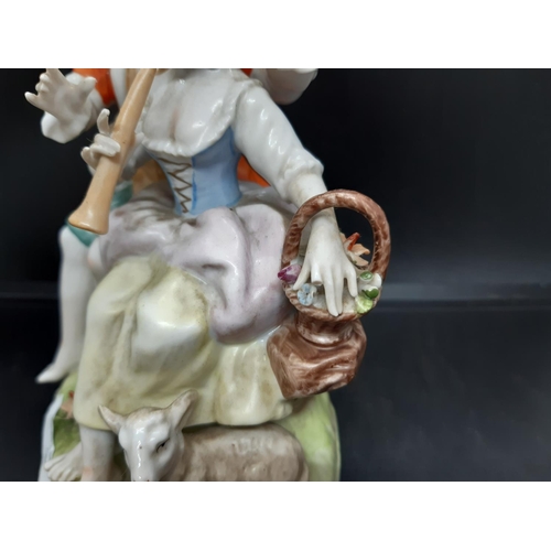 18 - A possibly German continental porcelain figurine of seated boy and girl with initial below five poin... 