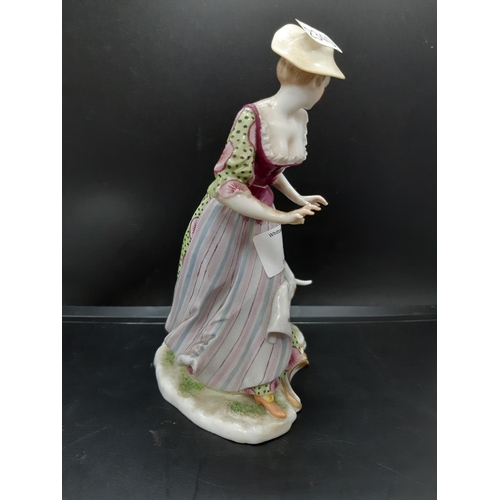 22 - A mid 20th century Ludwigsburg porcelain figurine of a dog attacking lady in dress with 