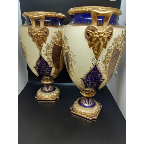 24 - A pair of excellent quality Coalport covered urns with hand painted scenes, each featuring a large b... 