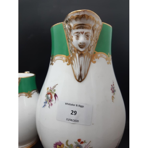 29 - A Victorian porcelain pitcher with serpent handle, satire faced spout with well detailed hand painte... 