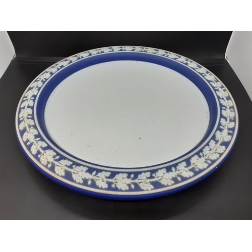 31 - A Wedgwood Jasperware cobalt blue cheese dome with putti and acanthus relief design and impressed 