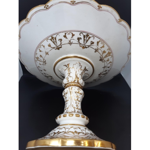 34 - An English porcelain table centrepiece with white ground and well detailed repeated gilded design wi... 