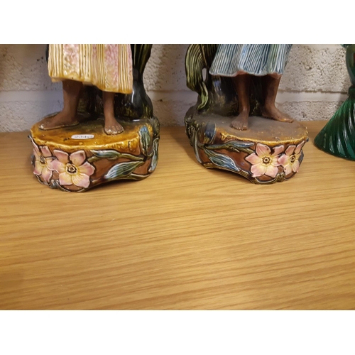 39 - A pair of tall Art Nouveau Majolica floor vases featuring tall flowers and buds, each having a Black... 