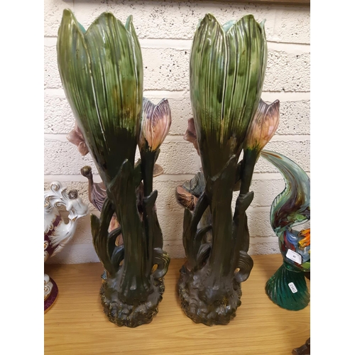 39 - A pair of tall Art Nouveau Majolica floor vases featuring tall flowers and buds, each having a Black... 