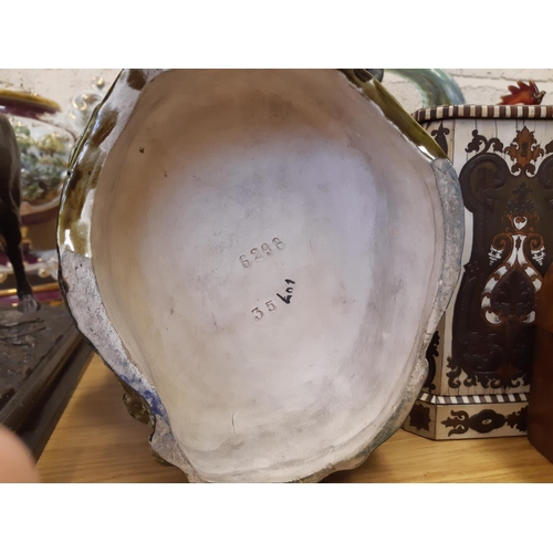 39 - A pair of tall Art Nouveau Majolica floor vases featuring tall flowers and buds, each having a Black... 