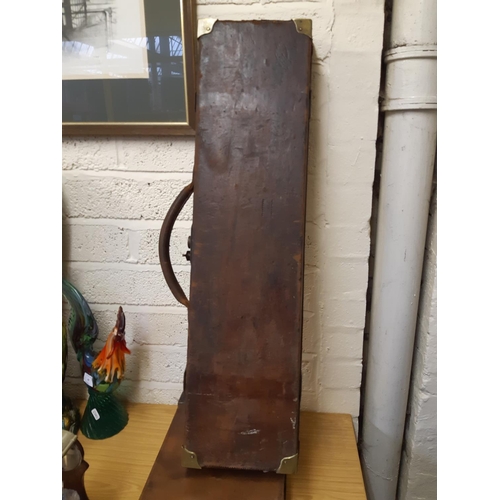 45 - A late 19th/early 20th century brown leather shotgun case, the exterior having heavy duty brass corn... 