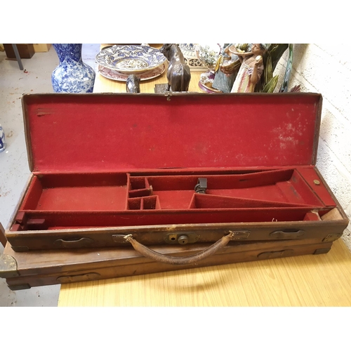 45 - A late 19th/early 20th century brown leather shotgun case, the exterior having heavy duty brass corn... 