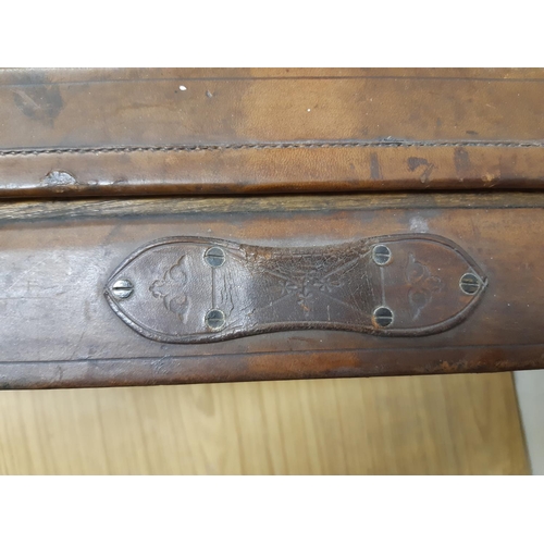 46 - A late 19th/early 20th century brown leather shotgun case, the exterior having heavy duty brass corn... 