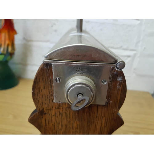 47 - An early 20th century oak Tantalus featuring silver plated corner supports, carry handles and escutc... 