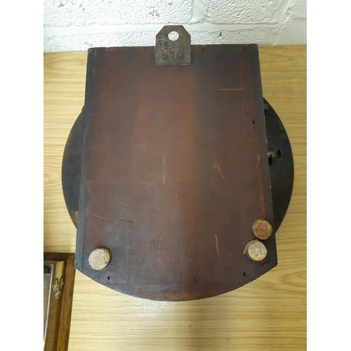 51 - A Victorian mahogany cased single fussee wall clock with off white enamel face, pendulum, brass beze... 