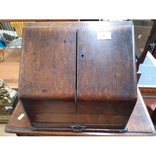 56 - An early 20th century oak stationary box / desk tidy with one lower drawer, pen holder, four section... 