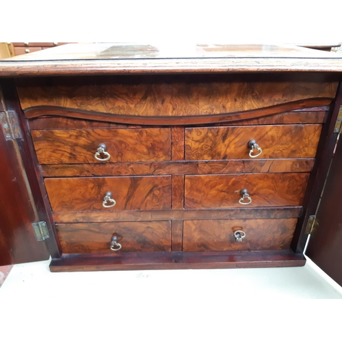 57 - A Victorian inlaid mahogany collectors cabinet with two doors and six drawers and one concealed draw... 