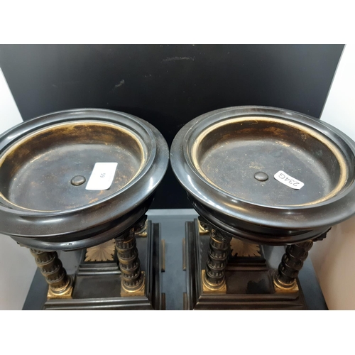 59 - A pair of French Aesthetic movement black marble and gilt metal clock garnitures / stands with circu... 