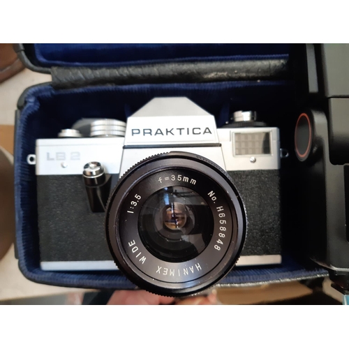 104 - A vintage black leather cased Praktica LB2 film camera with flash head, lens etc.