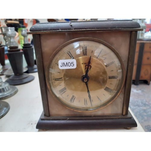 107 - Two vintage clocks to include a brass and glass cased Kundo style anniversary example and a Metamec ... 