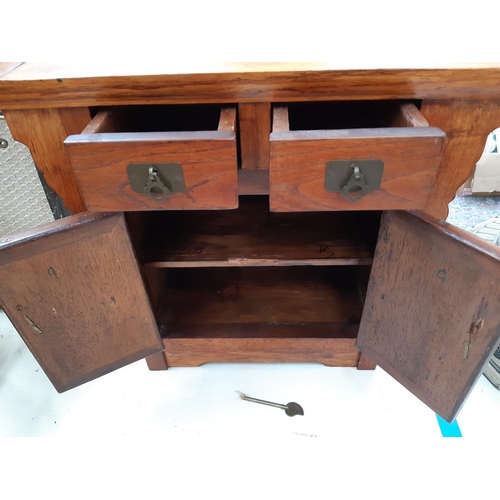 111 - A modern oriental influenced hardwood miniature cabinet/stool with two doors, two drawers and aged b... 