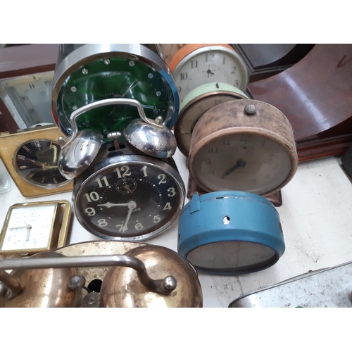 130 - A large collection of various travel and mantel clocks to include a Metamec teak cased wind up examp... 