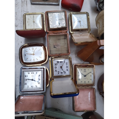 130 - A large collection of various travel and mantel clocks to include a Metamec teak cased wind up examp... 