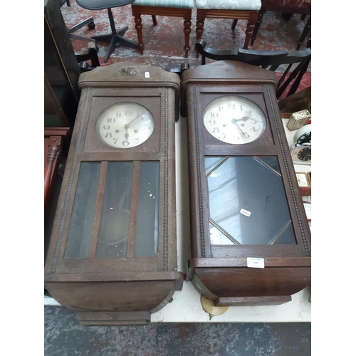 131 - Two vintage oak cased chiming wall clocks with silvered dials, both with keys and pendulums