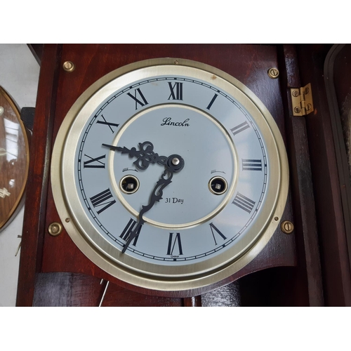 132 - Three various vintage wall clocks to include a Lincoln mahogany effect 31 day clock, Seiko 30 day cl... 