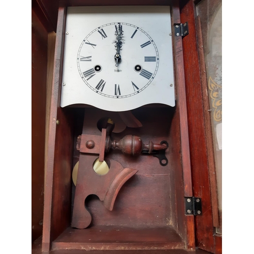 135 - Three vintage wall clocks to include an oak cased chiming clock and two mahogany effect 31 day chimi... 