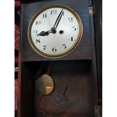 135 - Three vintage wall clocks to include an oak cased chiming clock and two mahogany effect 31 day chimi... 