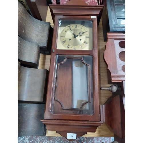 136 - A mahogany cased Metamec chiming wall clock with brass dial, key and pendulum