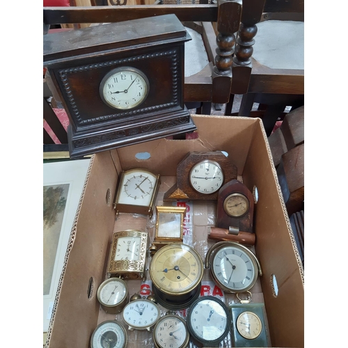 139 - A box containing a collection of various clocks to include a 1920s oak cased mantel clock with off w... 