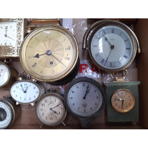 139 - A box containing a collection of various clocks to include a 1920s oak cased mantel clock with off w... 