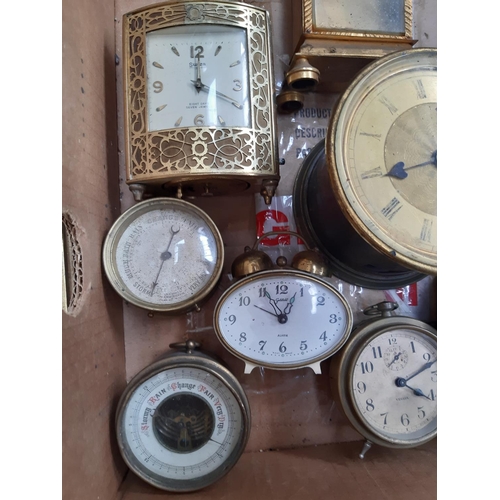 139 - A box containing a collection of various clocks to include a 1920s oak cased mantel clock with off w... 